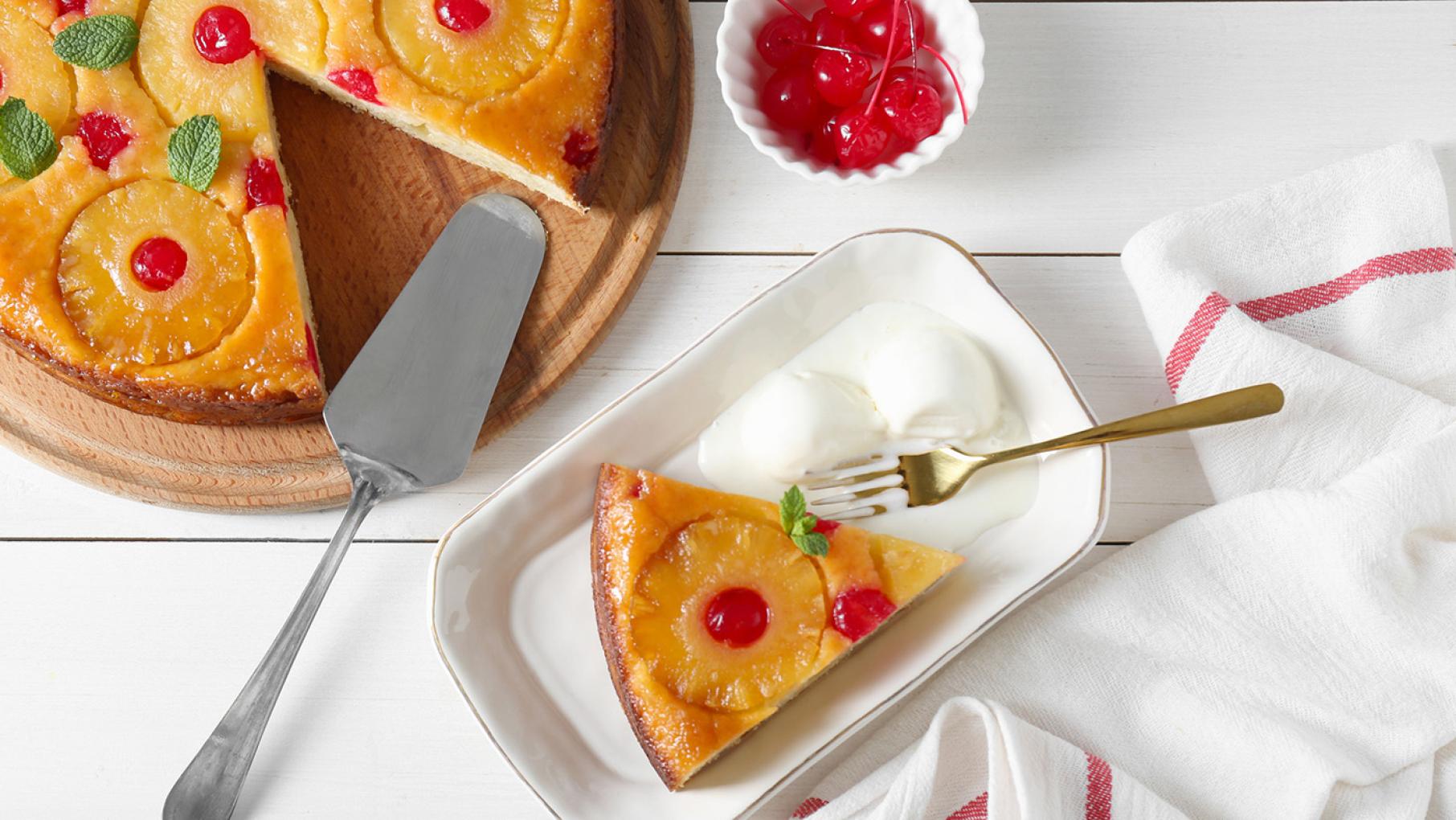 Budín de pan is a Puerto Rican bread pudding traditionally served at the holidays. Credit: PBS KIDS A slice taken out of a cake topped with pineapple rings and maraschino cherries