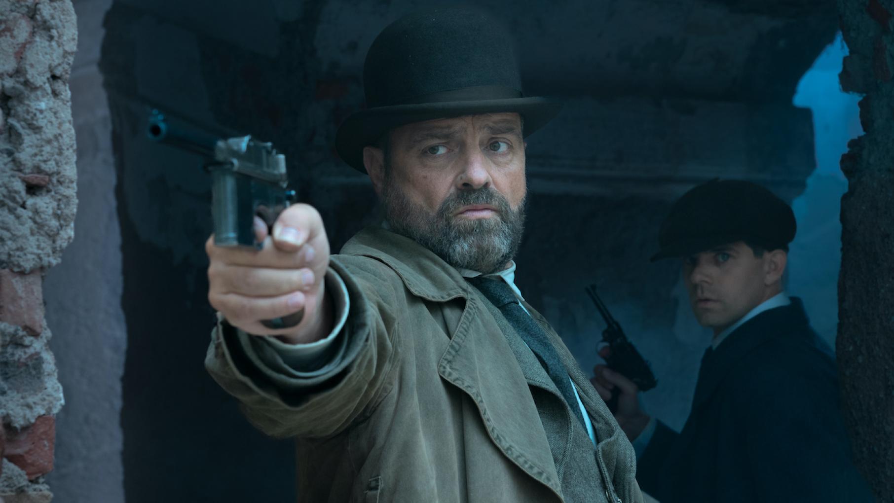 Oskar points a gun