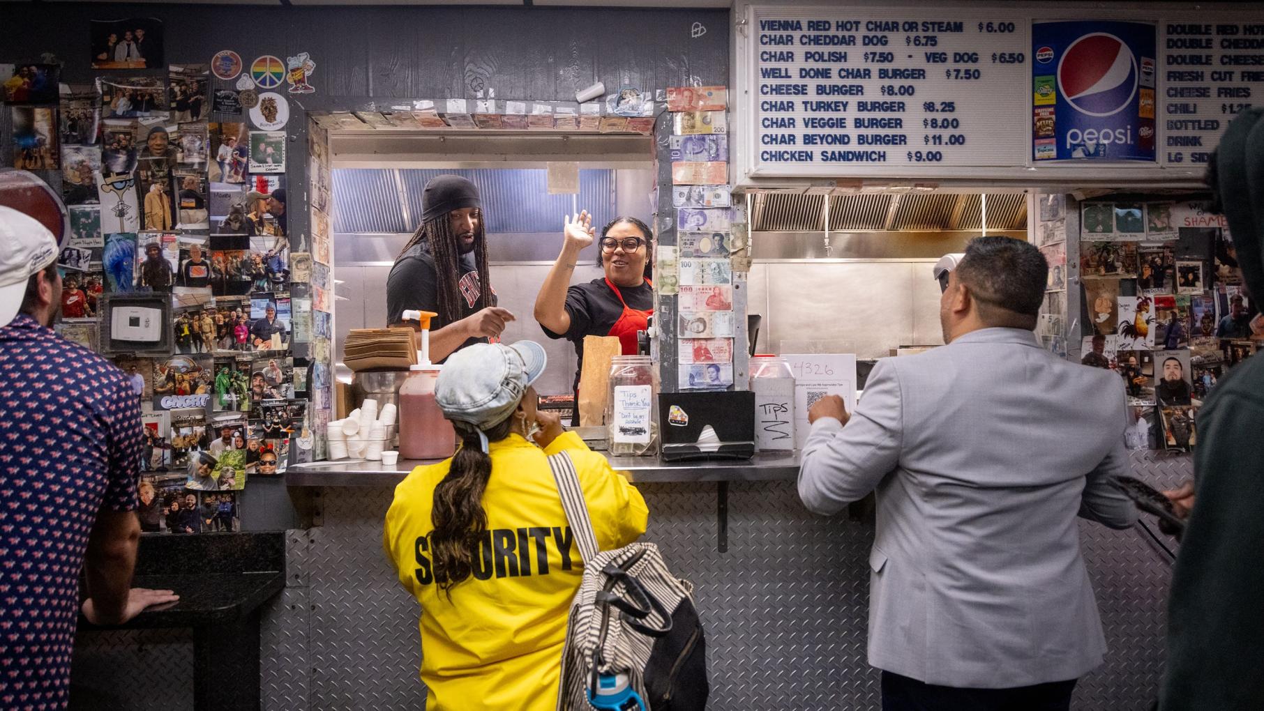 Jordan Brooks and Roberta “Poochie” Jackson work the late-night window at The Wiener’s Circle. Credit: Kathleen Hinkel for WTTW Jordan Brooks and Roberta “Poochie” Jackson