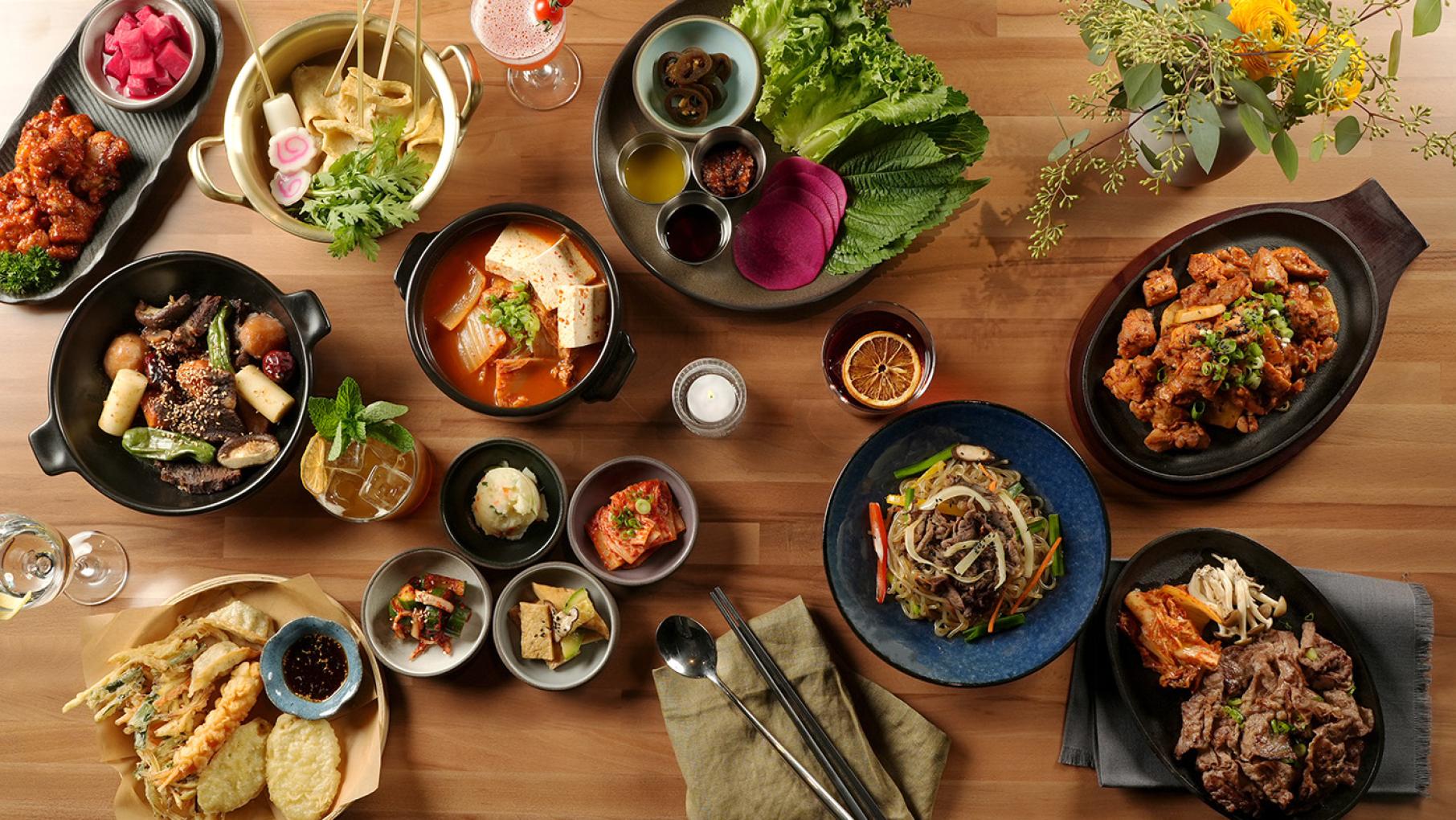 A spread of Korean dishes on a table seen from overhead