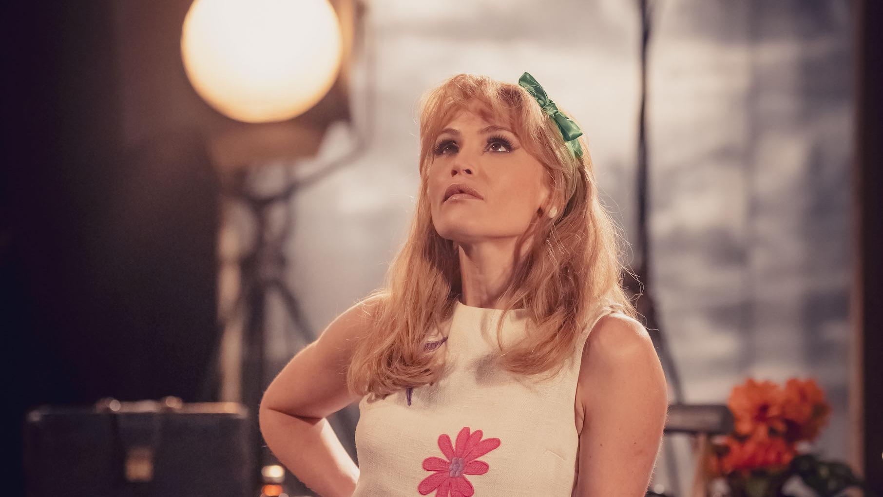 Sophie Straw looks up in front of a stage light