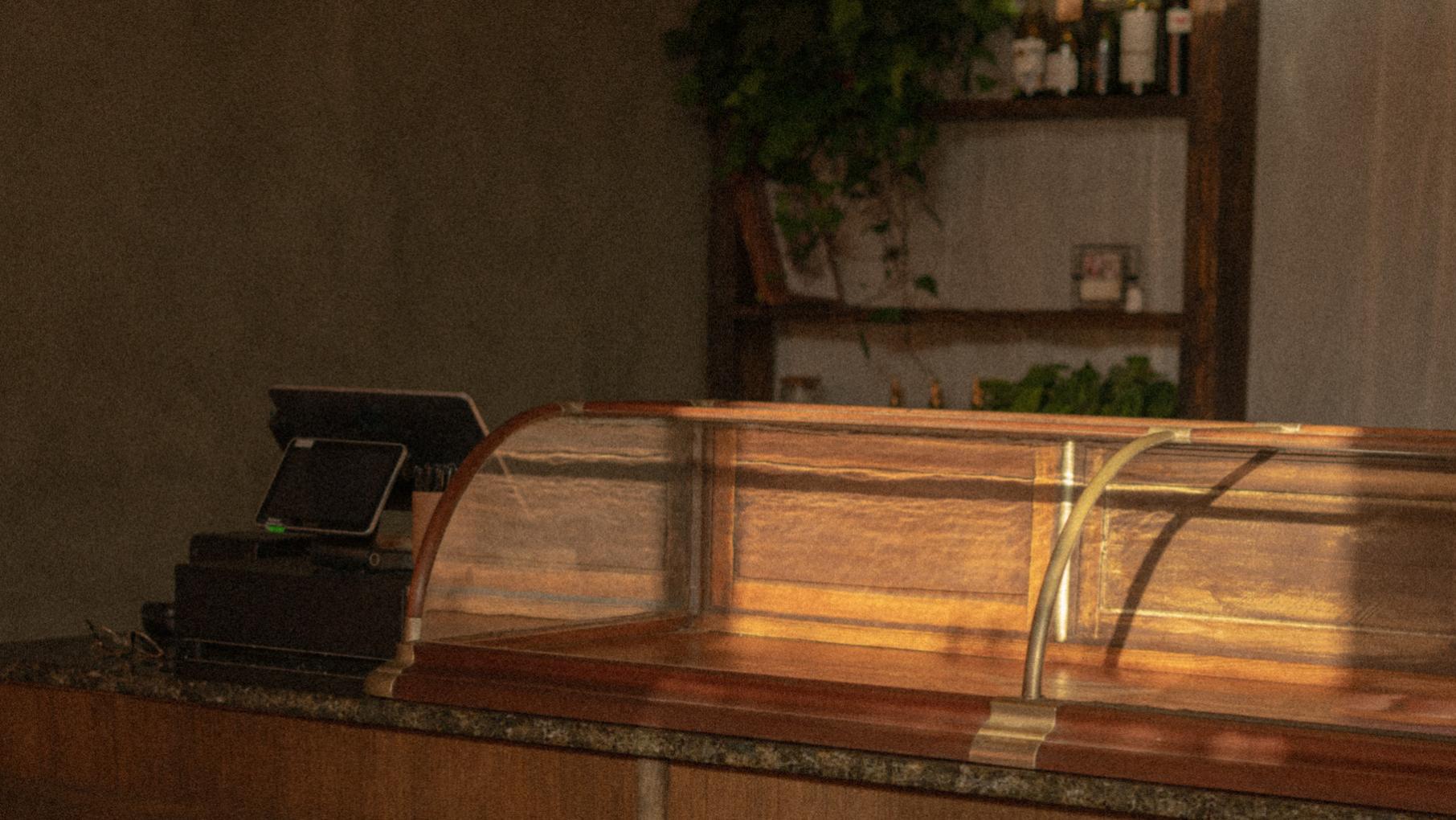 Sun falls on an empty display case in a bakery