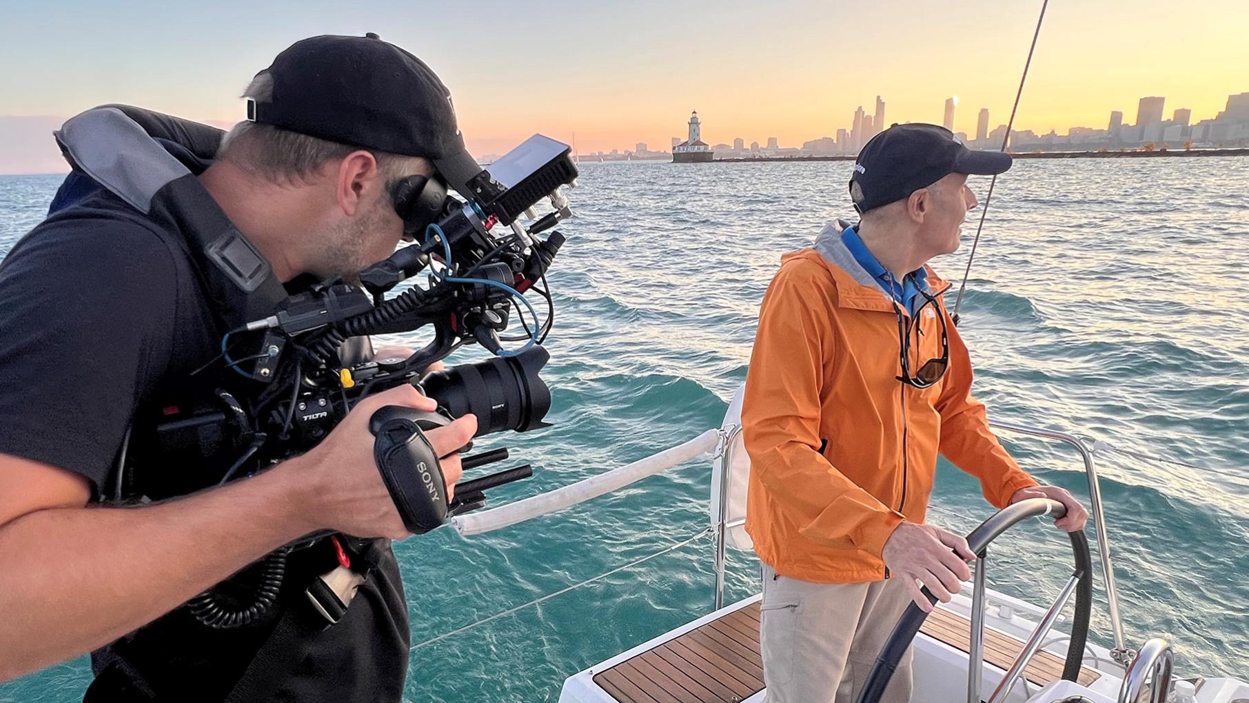 Geoffrey Baer explores Chicago's lakefront in his latest special Geoffrey Baer steers a boat while a cameraman films