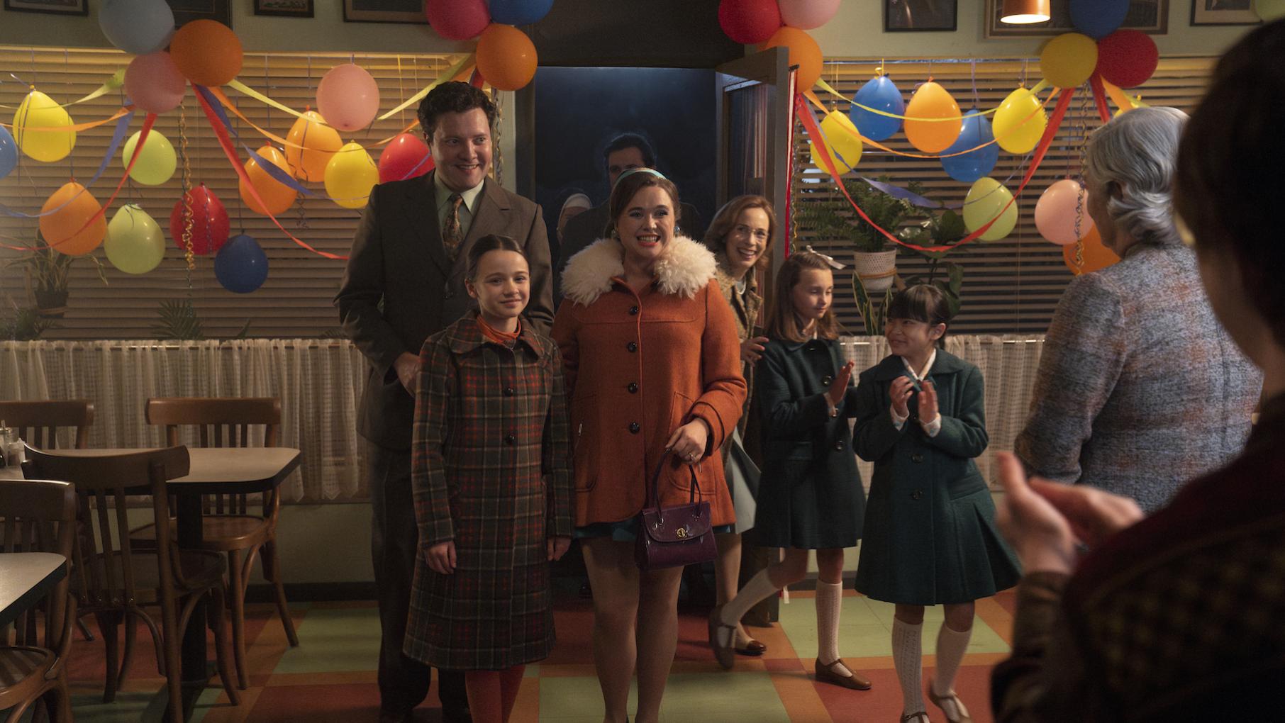 Nancy, Roger, Colette, and others enter a room decorated with balloons