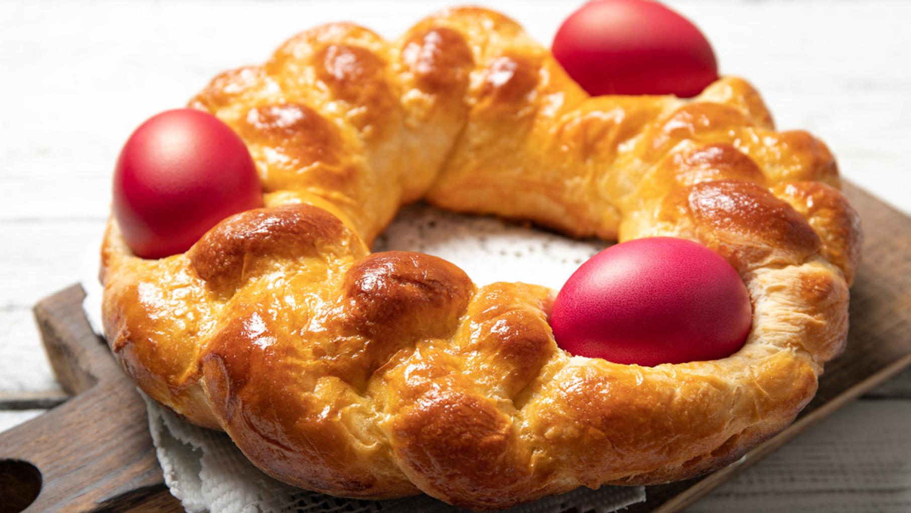 A circle of Easter bread with red eggs nestled in it