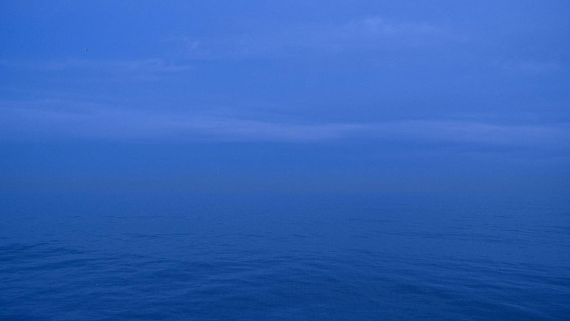 A photo of Lake Michigan, which features a blue sky over deeper blue water.