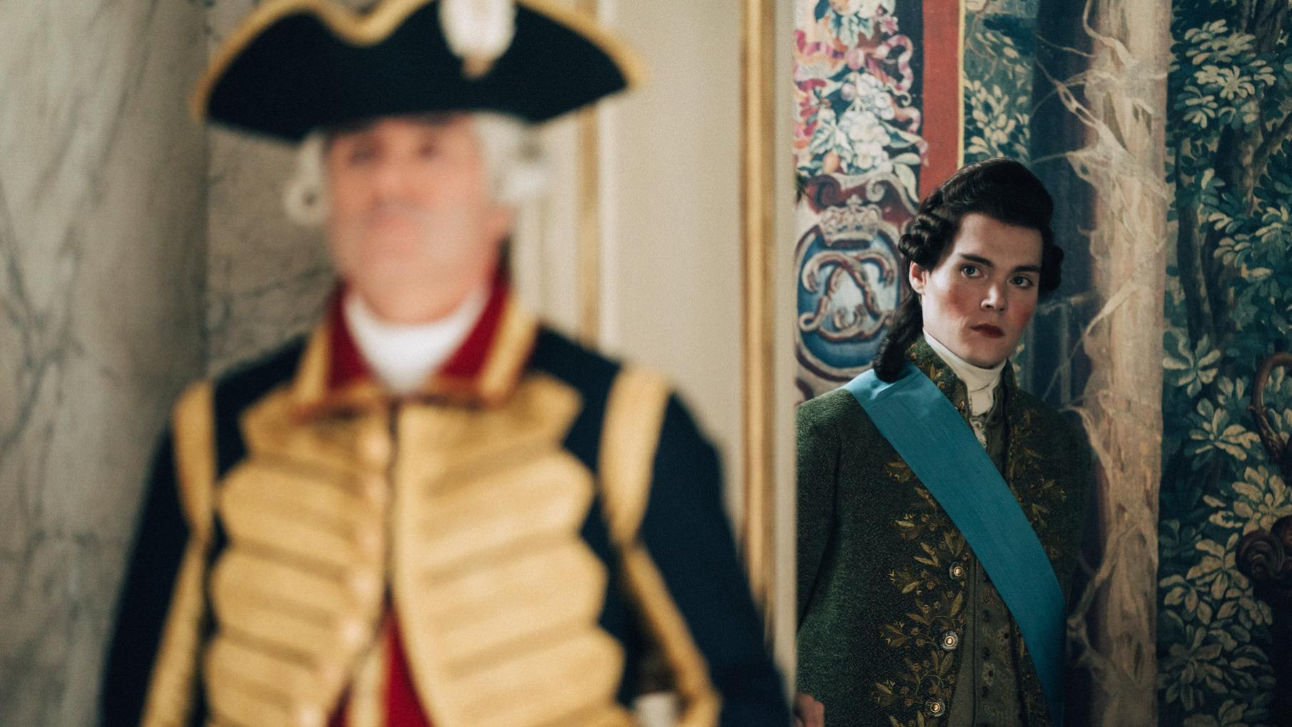 Provence schemes to discredit Louis in order to find his own way to the throne. Credit: Caroline Dubois for Capa Drama and Canal Plus Provence stands behind a guard