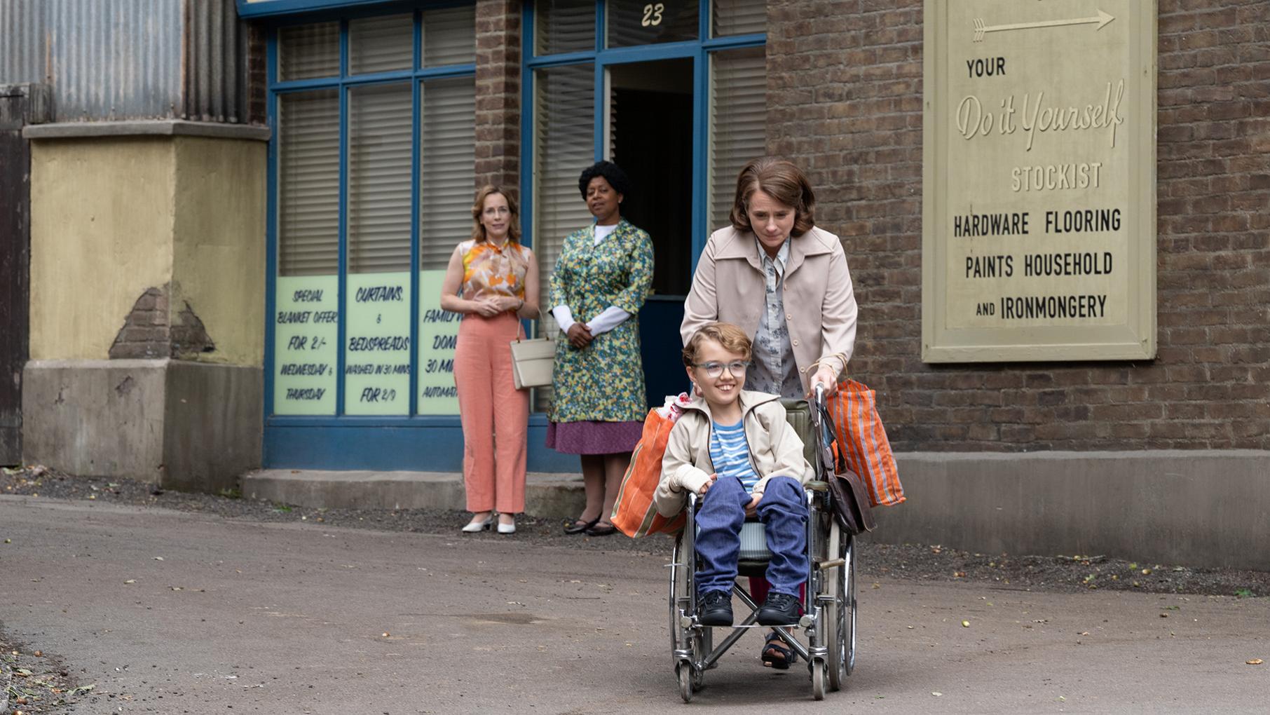 Andrew Trottwood suffered a brain infection after getting measles as a young child. Credit: BBC Studios A mother wheels her smiling son in a wheelchair away from a laundromat