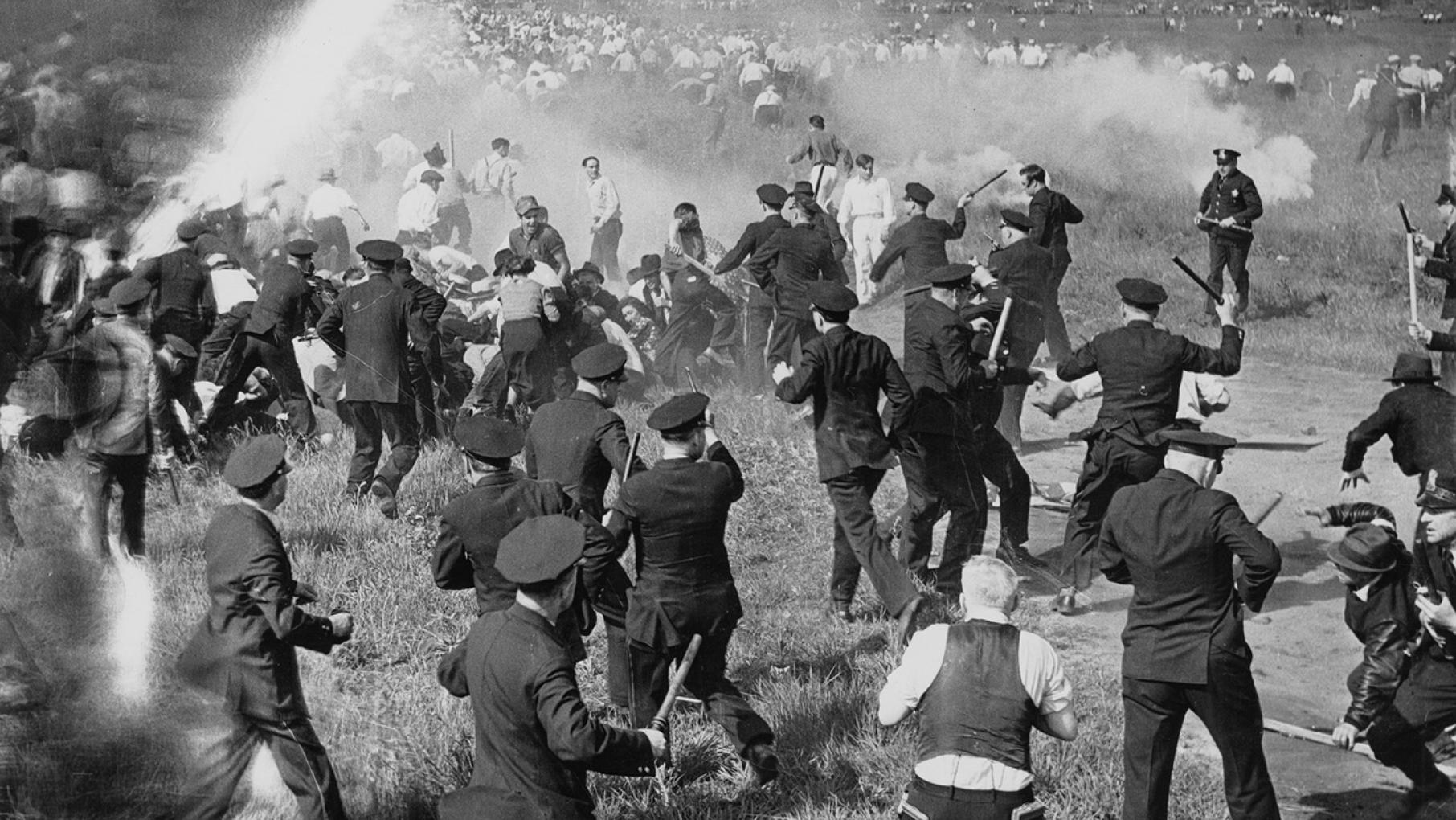Police confront strikers outside Republic Steel in Chicago during what became known as the Memorial Day Massacre on May 30, 1937. Credit: DN-C-8769A, Chicago Sun-Times/Chicago Daily News collection, Chicago History Museum A black and white image showing a chaotic protest scene, in which officers are wielding clubs at protestors