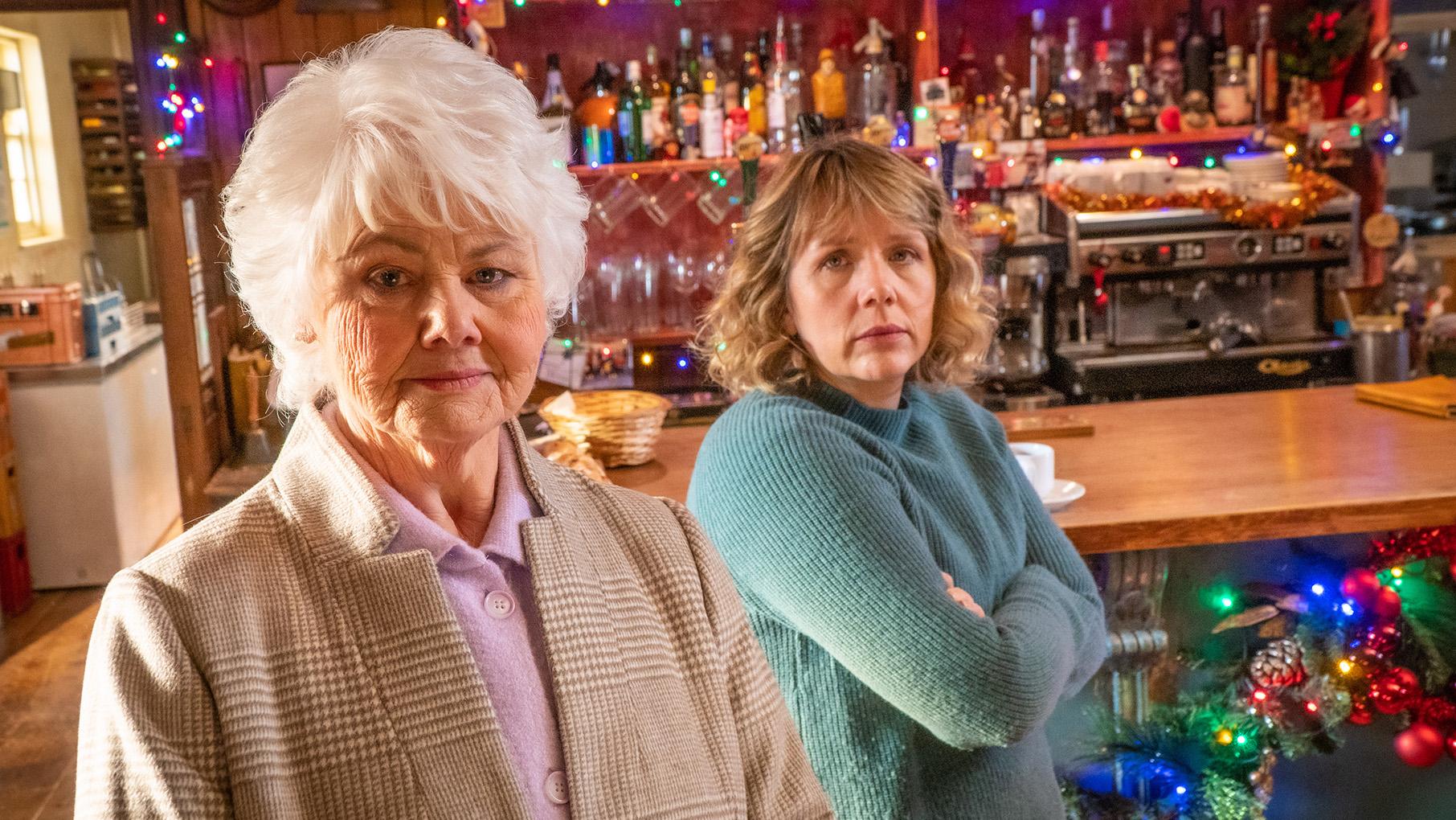 Rosie believes her son-in-law has tried to sabotage his ex-wife in order to spend more time with his daughter A woman with white hair and another woman stand in front of a bar and look at the camera