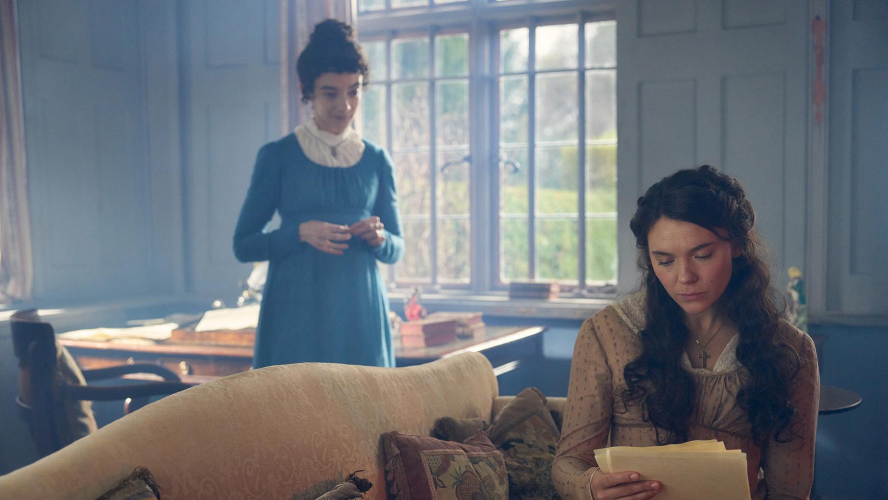 After melancholy, trying times, Jane finally manages to publish some novels. Credit: Masterpiece Cassy reads from pages on a couch while Jane stands expectantly behind