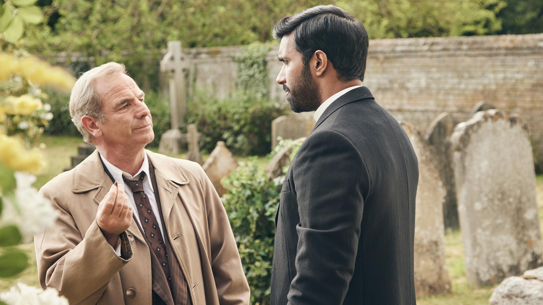 Geordie holds up a bullet to Alphy in a graveyard