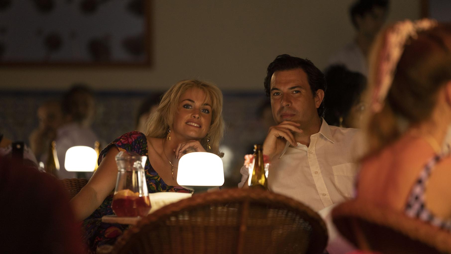 'The Gold' is about a 1983 robbery that was the largest in the world at the time. Credit: Masterpiece A man and woman sitting at a table smile at something