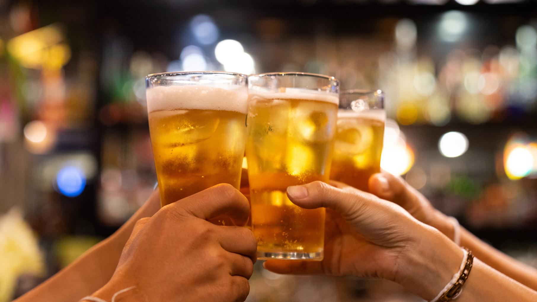 Credit: krisanapong detraphiphat / iStock Hands holding up beer glasses in a "cheers"