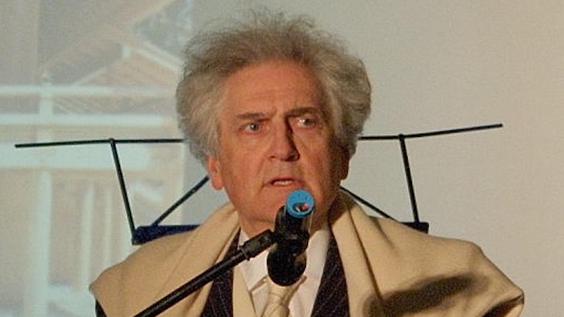 Léon Krier was an influential architect and theorist who rejected modernism in favor of classical architecture and traditional urban layouts. Credit: Archy-art/Wikimedia Commons Leon Krier behind a microphone
