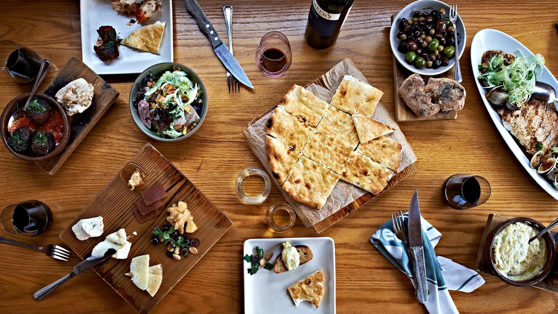 A spread of food and wine on a table