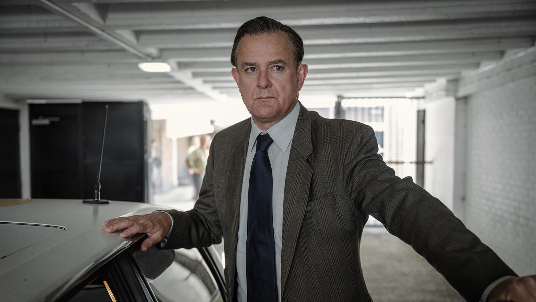 Boyce stands next to a car