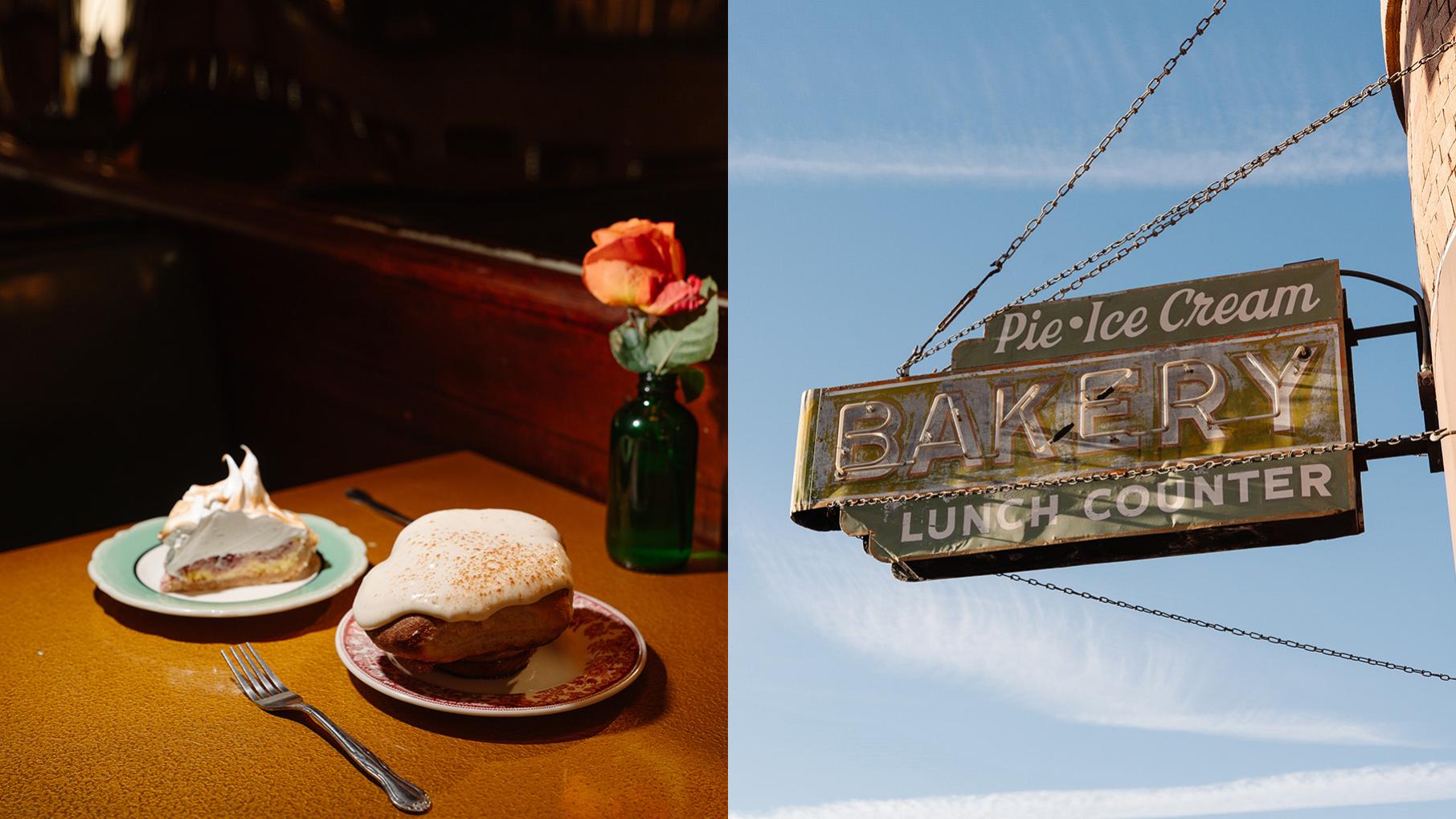 A slice of pie and a cinnamon bun on a table in a dark room next to a photo of the Spinning J neon sign against a blue sky