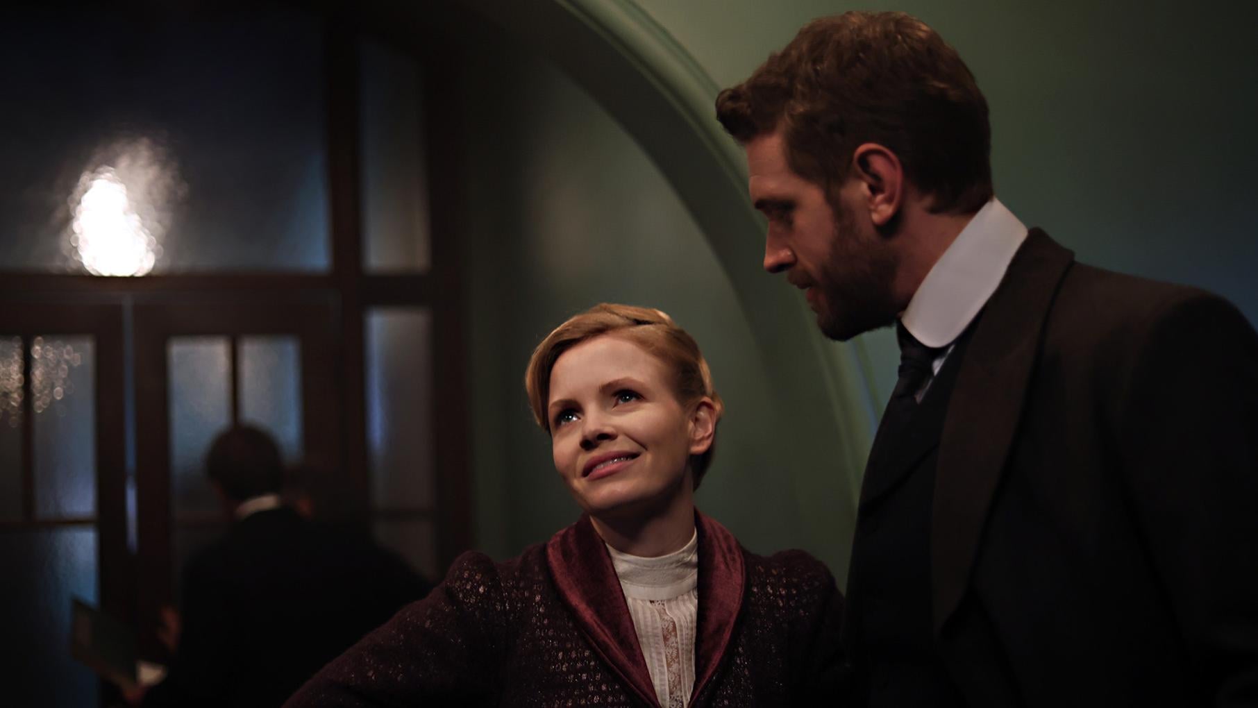 Eliza looks up while Alexander looks down at her