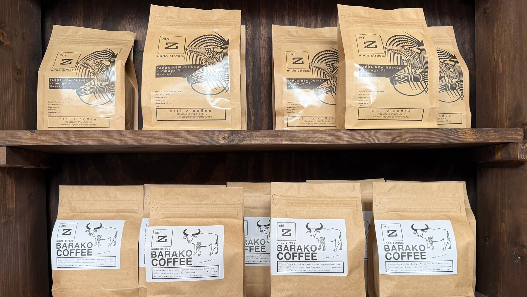 Bags of coffee on two wooden shelves