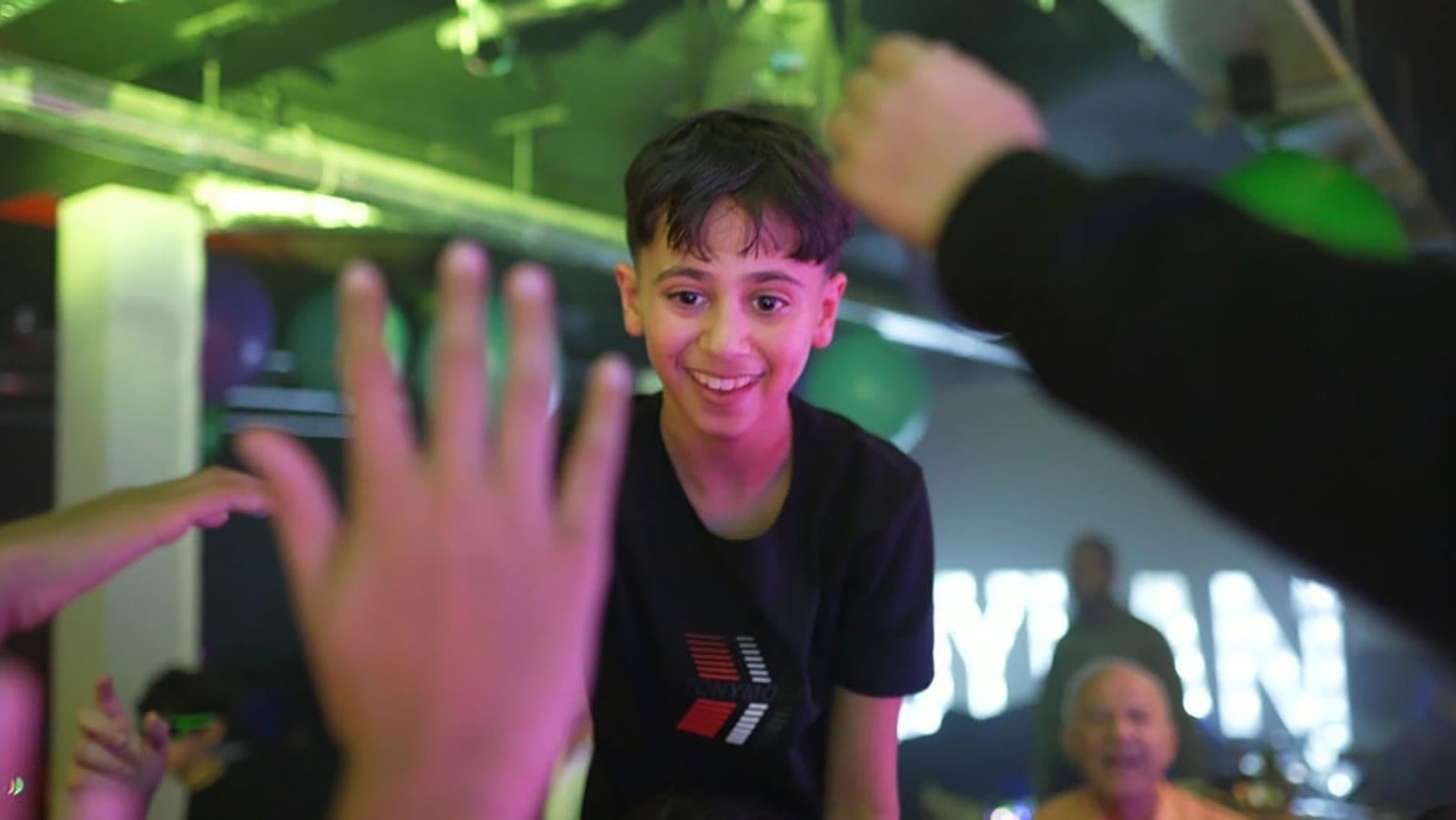A boy smiling at a bar mitzvah