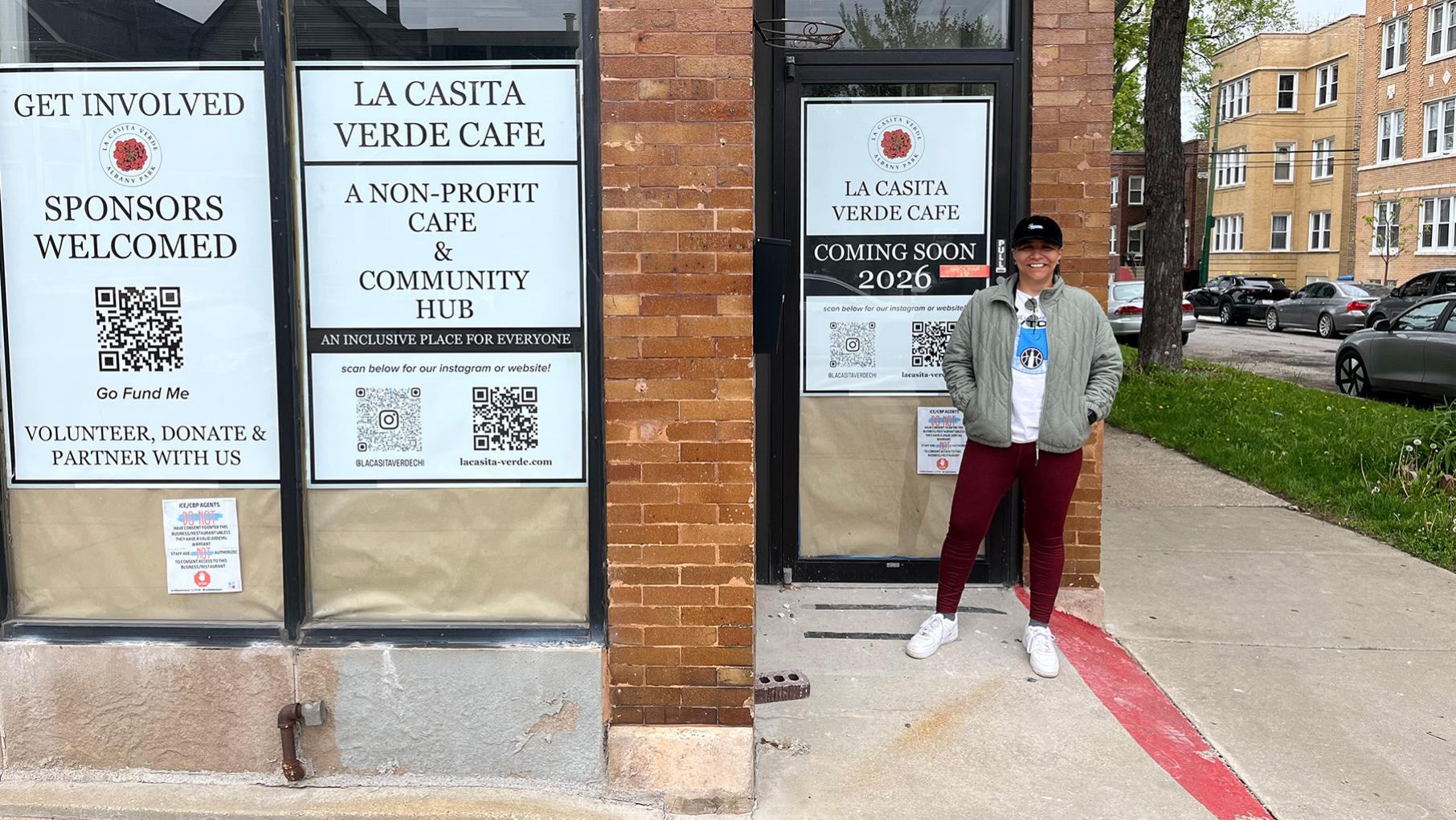 Martha Del Rio Stands outside a cafe with posters on the windows