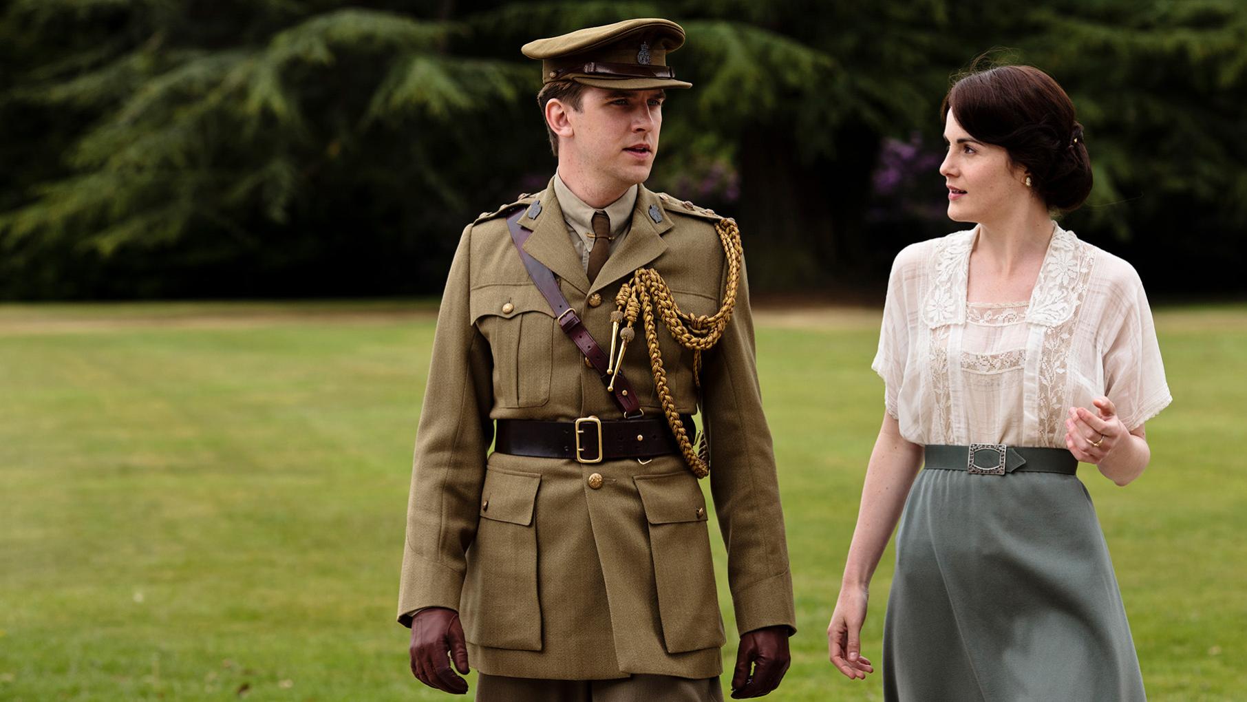 Matthew in his military uniform walks with Mary on the grounds of Downton Abbey