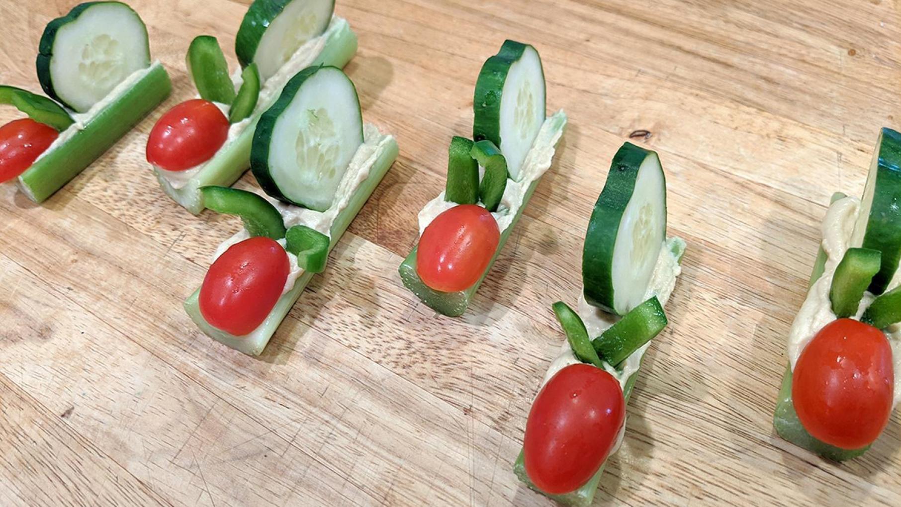 "Snails" made of cucumber, celery, and tomato