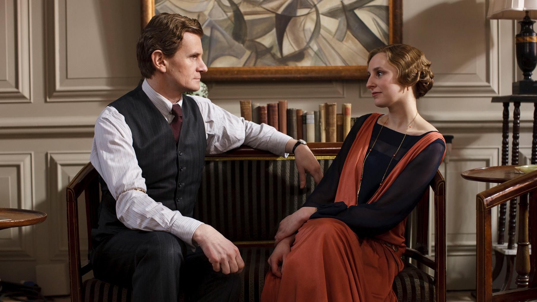 Gregson sit facing each other in an office
