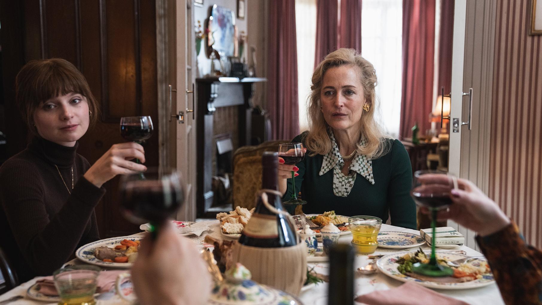 Cushla and Gina raise glasses at a table