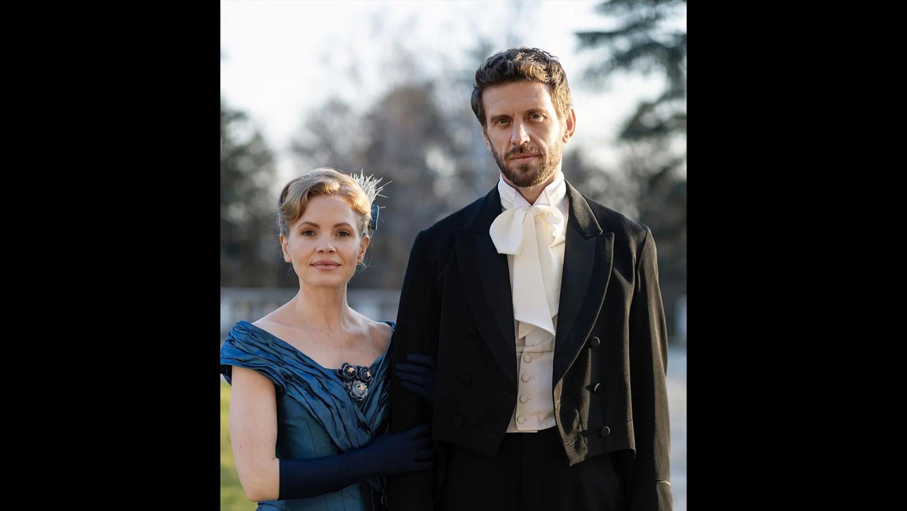 Eliza stands next to Alexander outside