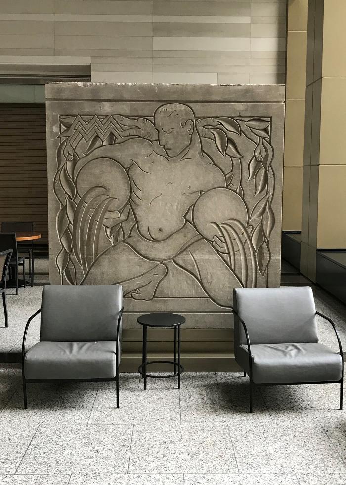 A sculptural panel of Aquarius by Eugene and Gwen Lux depicting Aries that originally decorated the facade of the McGraw-Hill Building and is now located in the Shops at North Bridge
