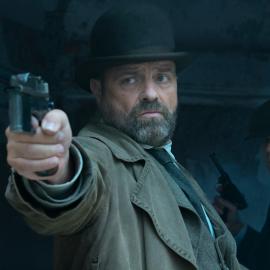 Oskar points a gun