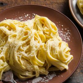 A plate of fettucine alfredo on a table