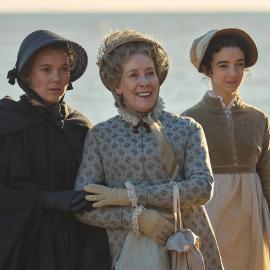 The Austen women stand on the beach