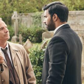 Geordie holds up a bullet to Alphy in a graveyard