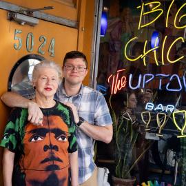 Michelle Fire and Michael Sanders stand together in front of Big Chick's, smiling and posing for the photo.