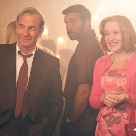 Geordie and Cathy smile at something while Alphy stands behind them