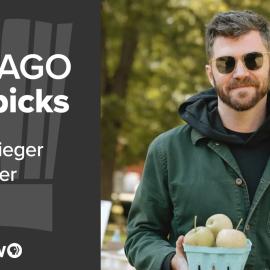 Sieger Bayer smiles while holding a container of apples outside