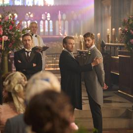 The Forsyte men stand in front of the altar and a crowd in a church