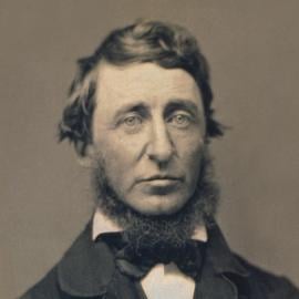 A black and white photo portrait of a bearded Henry David Thoreau in a suit