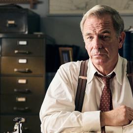 Geordie sits at his desk at the police station