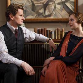 Gregson sit facing each other in an office