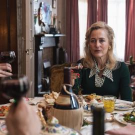 Cushla and Gina raise glasses at a table