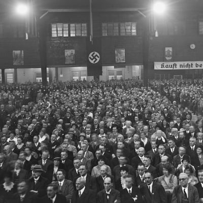 Nazi Party political rally. Sign in the back reads, "Don't buy from Jews." Photo: Courtesy National Archives and Records Administration